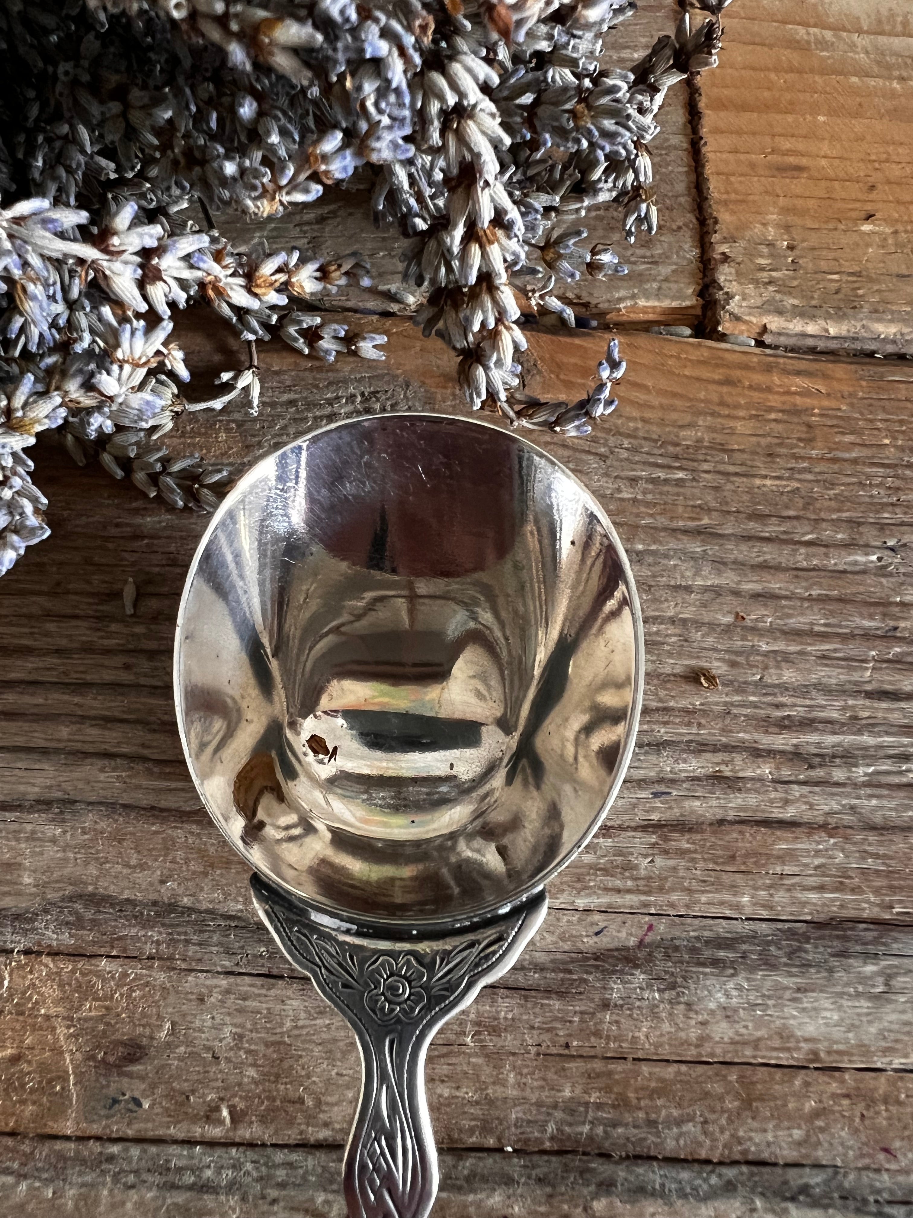 Verzilverde koffieschep Douwe Egberts