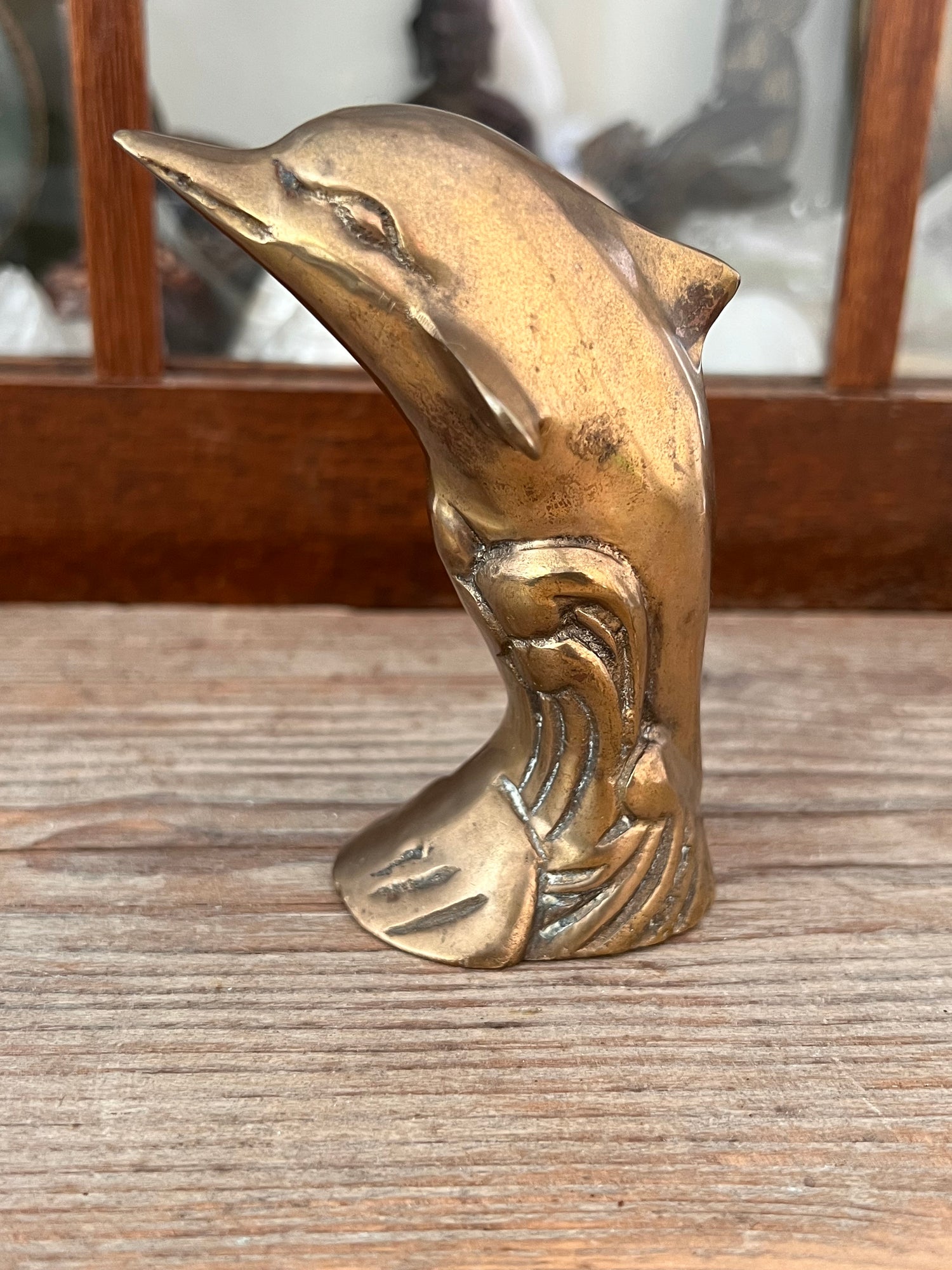 Brass dolphin jumping