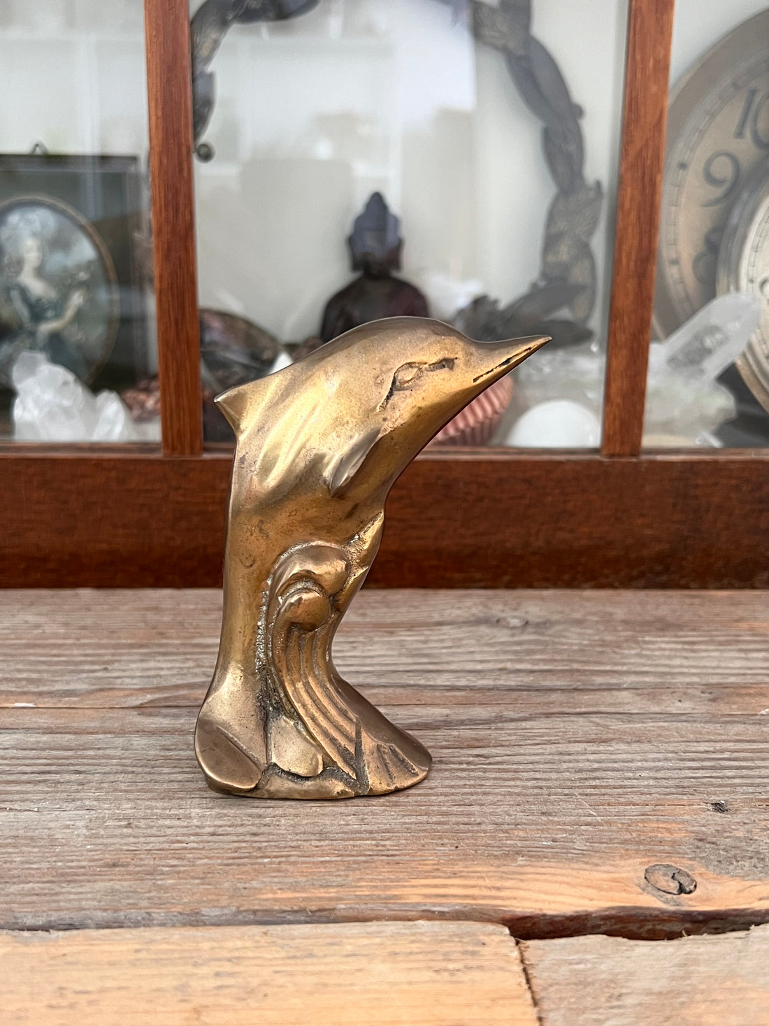 Brass dolphin jumping