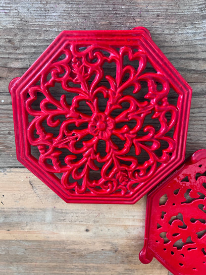 rode onderzetter gietijzer, vintage onderzetter pannen, gietijzeren onderzetter retro, onderzetter voor hete pannen, vintage keukenaccessoires, gietijzeren pannendrager, retro pannenonderzetter, keukendecor vintage.