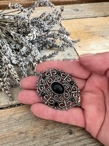 Broche antieklook zwart